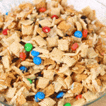 This Gooey Chex Mix is the perfect treat -- filled with Chex, Golden Grahams, Cashews, M&M's and more! Everyone will love this! From overthebigmoon.com!