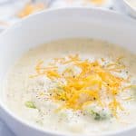 The BEST Broccoli Cheese Soup -- super creamy with chunks of vegetables in it to create texture! From overthebigmoon.com!