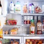 Organized Fridge using organizing bins and vinyl labels made with the Cricut Maker.